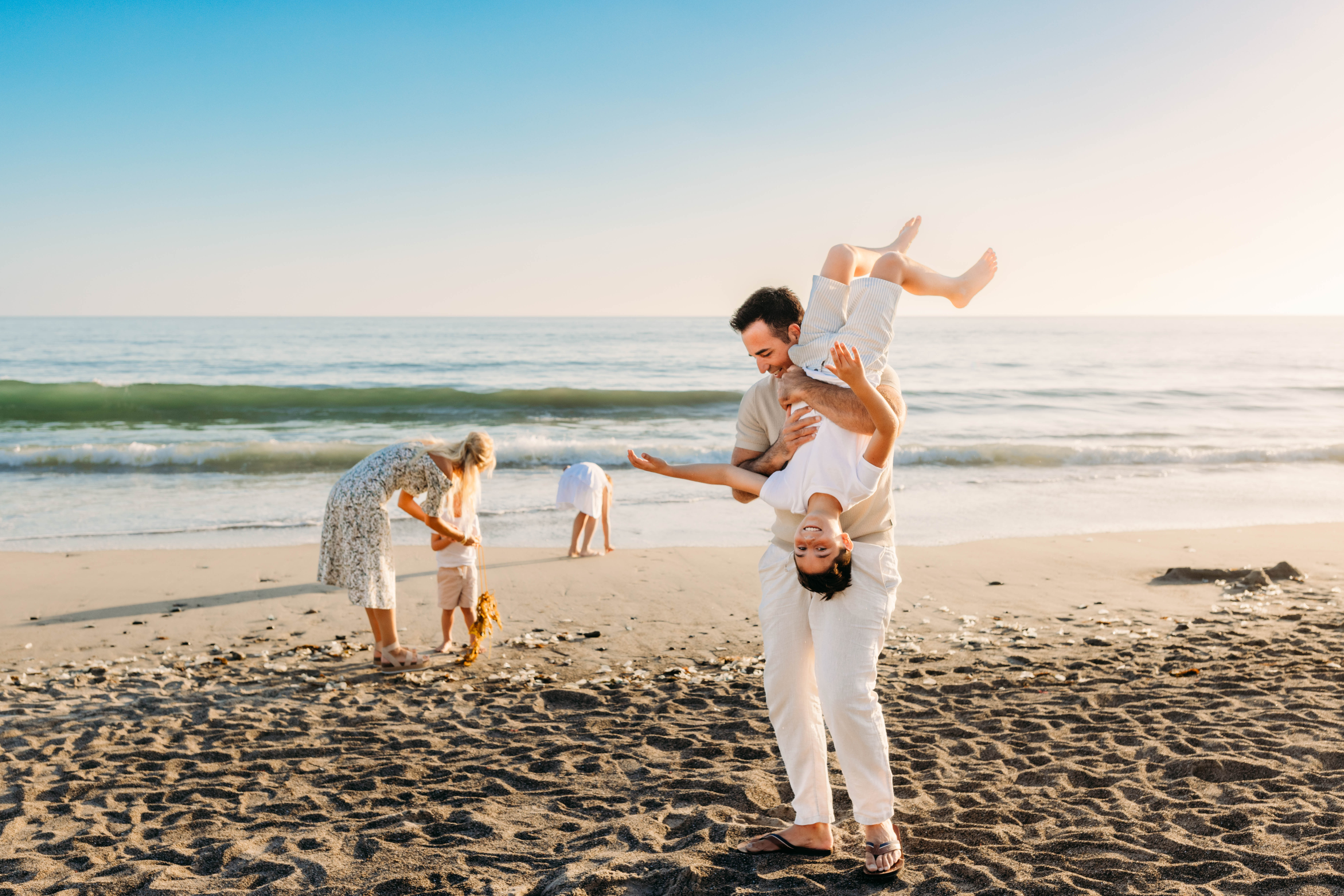 Family of five playing at the beach in San Clemente, California