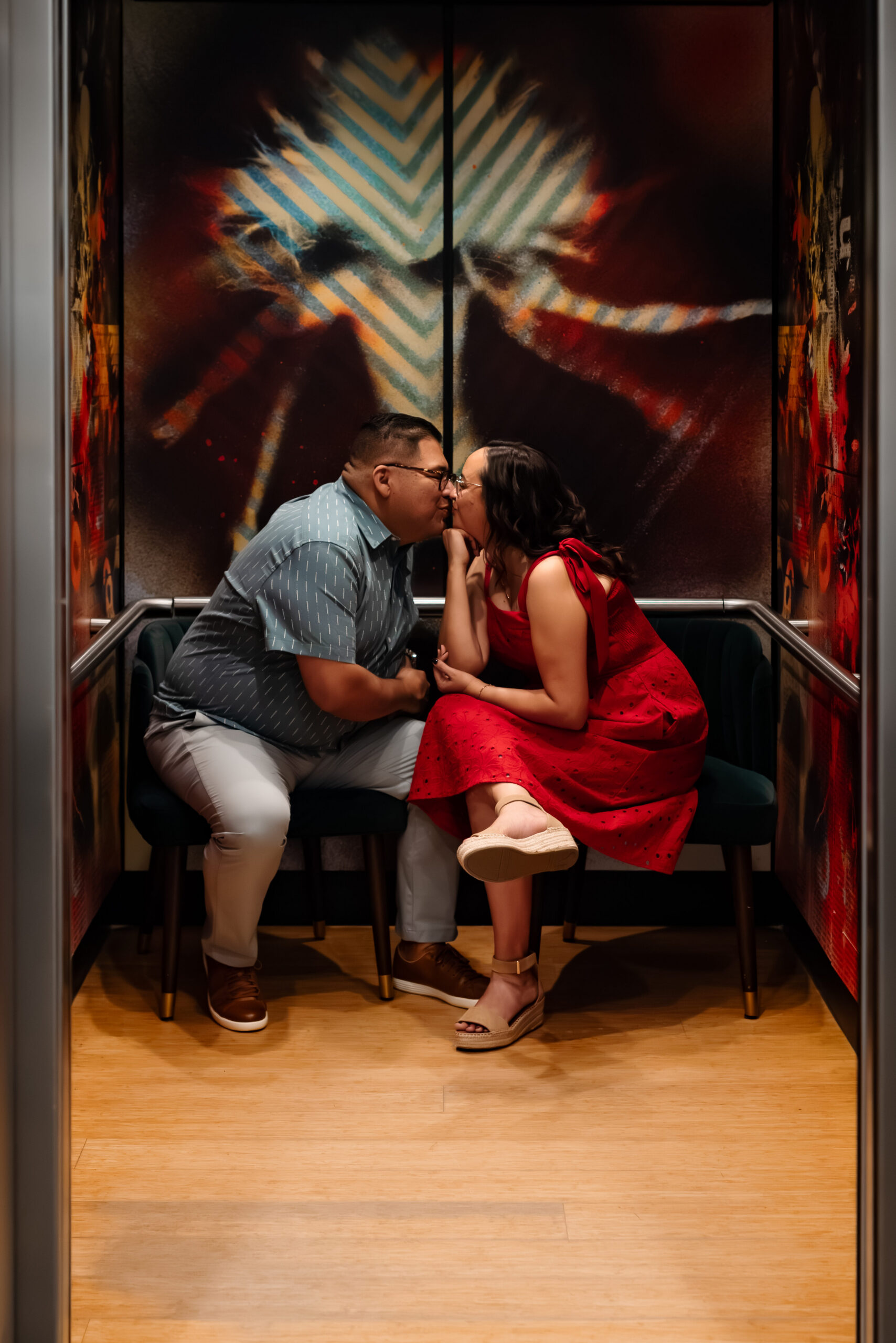 couple kissing inside elevator at art museum in Laguna California