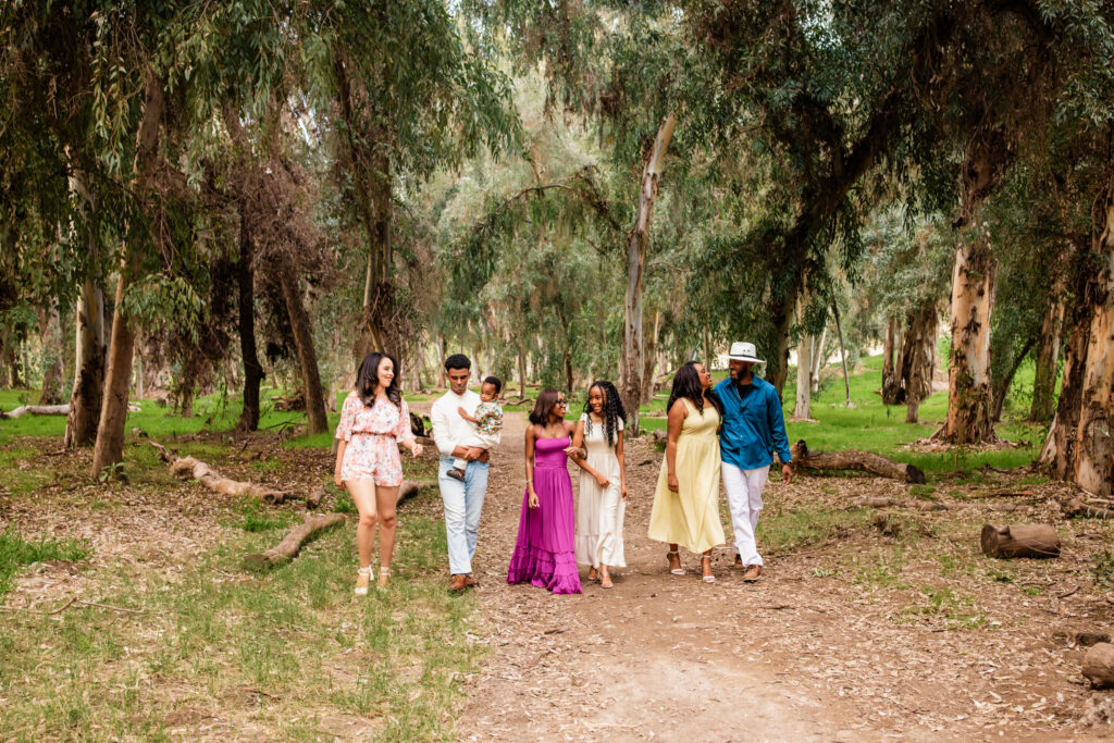 African American family of 7 walking through a nature setting laughing and talking together in Murrieta California